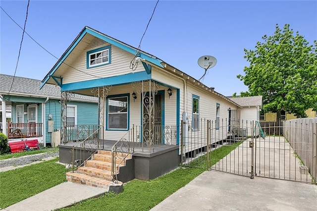 8711 Olive St, New Orleans, LA 70118 - shotgun-style home with a gate and covered porch