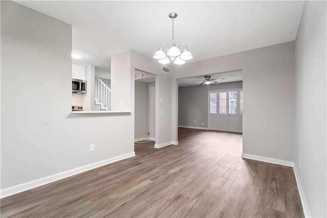 5720 Count Ln, New Orleans, LA 70126 - spare room with a chandelier, wood finished floors, stairway, and ceiling fan