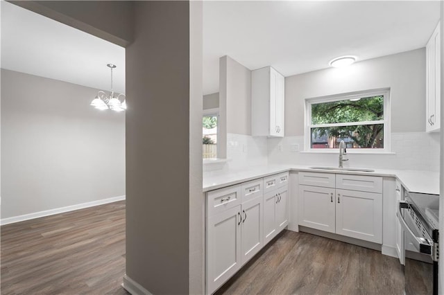 5720 Count Ln, New Orleans, LA 70126 - kitchen with stove, dark wood-style floors, backsplash, and white cabinets