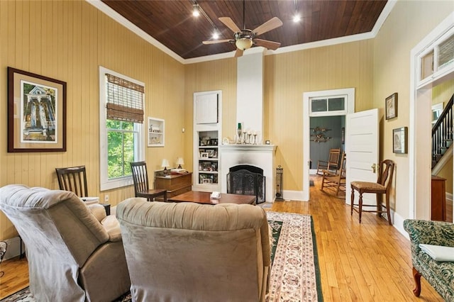 39267 Z Oaks Ln, Ponchatoula, LA 70454 - living area featuring wood-type flooring, a fireplace, wooden ceiling, crown molding, and ceiling fan