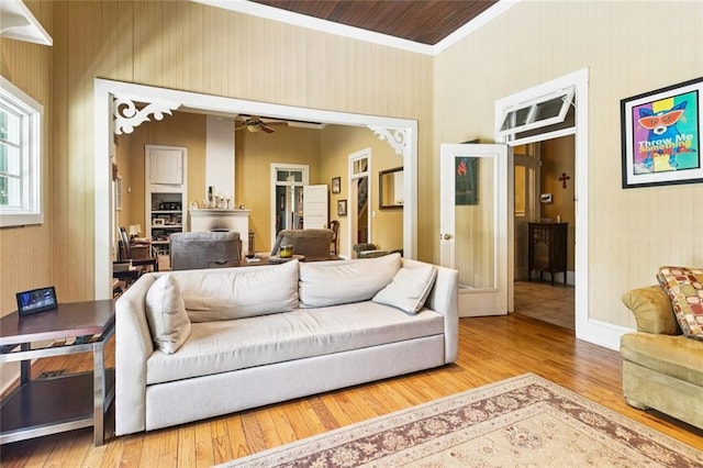 39267 Z Oaks Ln, Ponchatoula, LA 70454 - living room featuring french doors, wood-type flooring, crown molding, ceiling fan, and wood walls