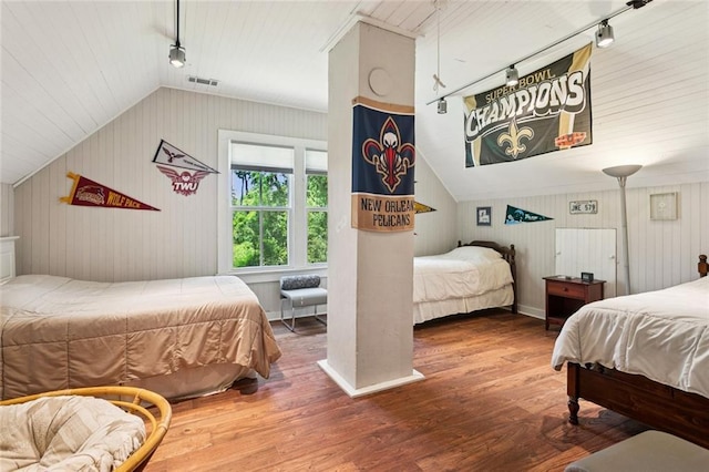 39267 Z Oaks Ln, Ponchatoula, LA 70454 - bedroom featuring track lighting, vaulted ceiling, wood finished floors, and wooden walls