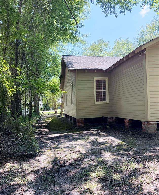 312 W 20th Ave, Covington, LA 70433 - view of home's exterior featuring roof with shingles