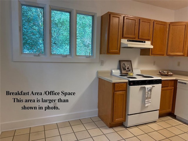 312 W 20th Ave, Covington, LA 70433 - kitchen with under cabinet range hood, white appliances, brown cabinets, and light countertops