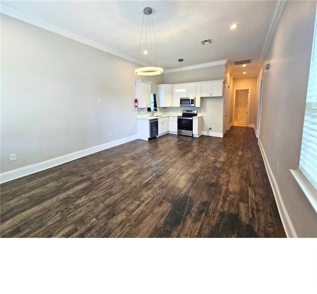 1717 Governor Nicholls St, New Orleans, LA 70116 - unfurnished living room featuring dark wood-type flooring, crown molding, and recessed lighting