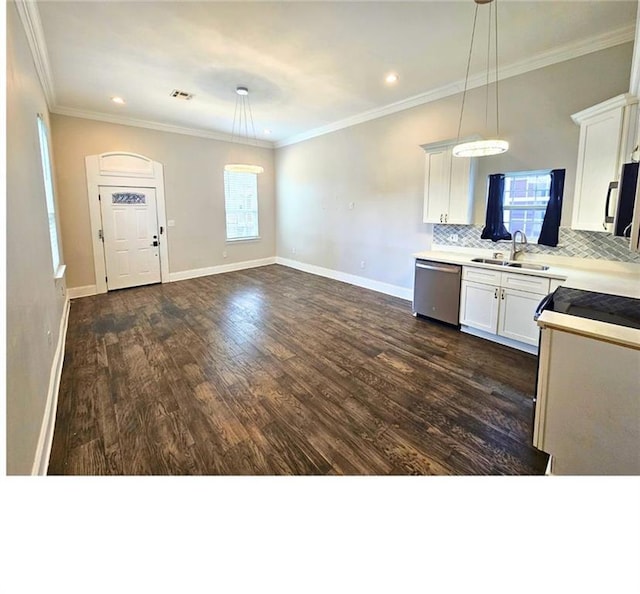 1717 Governor Nicholls St, New Orleans, LA 70116 - kitchen featuring stainless steel appliances, light countertops, dark wood-style floors, hanging light fixtures, and decorative backsplash