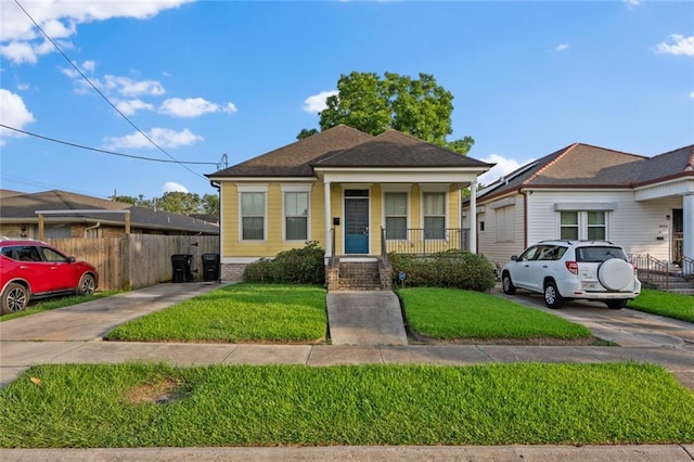 2060 Saint Denis St, New Orleans, LA 70122 - view of front of home featuring covered porch, concrete driveway, and roof with shingles