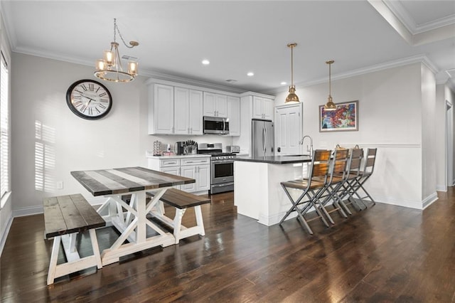 2060 Saint Denis St, New Orleans, LA 70122 - kitchen with stainless steel appliances, a chandelier, recessed lighting, dark wood-style flooring, and white cabinetry