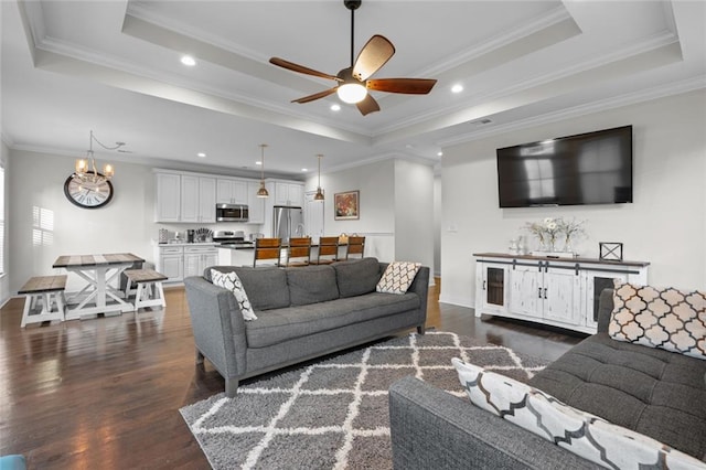 2060 Saint Denis St, New Orleans, LA 70122 - living area with a raised ceiling, dark wood-style floors, a chandelier, a ceiling fan, and ornamental molding