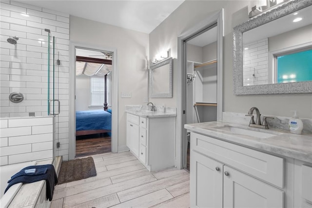 2060 Saint Denis St, New Orleans, LA 70122 - ensuite bathroom featuring a shower stall, wood finished floors, and two vanities