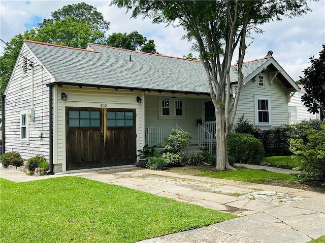 402 Orion Ave, Metairie, LA 70005 - view of front of property with a shingled roof, driveway, an attached garage, and a front yard