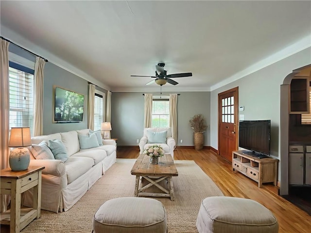 402 Orion Ave, Metairie, LA 70005 - living area with arched walkways, crown molding, ceiling fan, and light wood finished floors