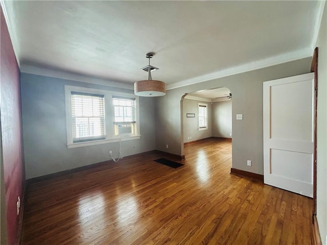 402 Orion Ave, Metairie, LA 70005 - spare room featuring crown molding, wood finished floors, arched walkways, and cooling unit