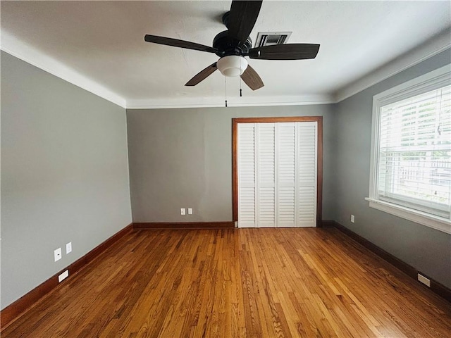 402 Orion Ave, Metairie, LA 70005 - unfurnished bedroom featuring wood finished floors, a closet, crown molding, and ceiling fan