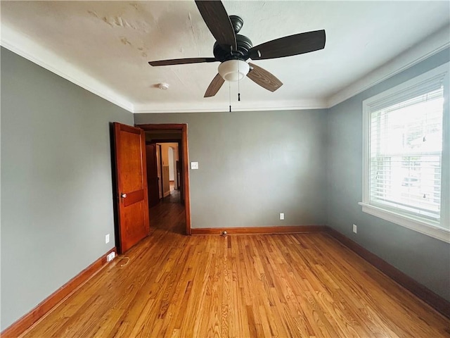 402 Orion Ave, Metairie, LA 70005 - spare room featuring light wood-style floors, crown molding, and ceiling fan