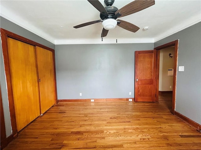 402 Orion Ave, Metairie, LA 70005 - unfurnished bedroom with light wood-type flooring, ornamental molding, a closet, and a ceiling fan