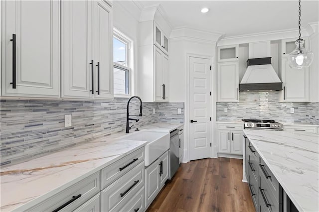 7717 Richard St, Metairie, LA 70003 - kitchen with custom range hood, stainless steel appliances, white cabinets, dark wood-type flooring, and crown molding