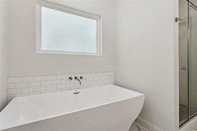 69206 4th Ave, Covington, LA 70433 - full bath with a freestanding bath, a stall shower, and marble finish flooring