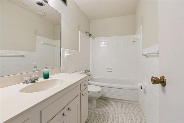 2700 Whitney Pl Unit 826, Metairie, LA 70002 - bathroom featuring tile walls, washtub / shower combination, vanity, tile patterned floors, and a wainscoted wall