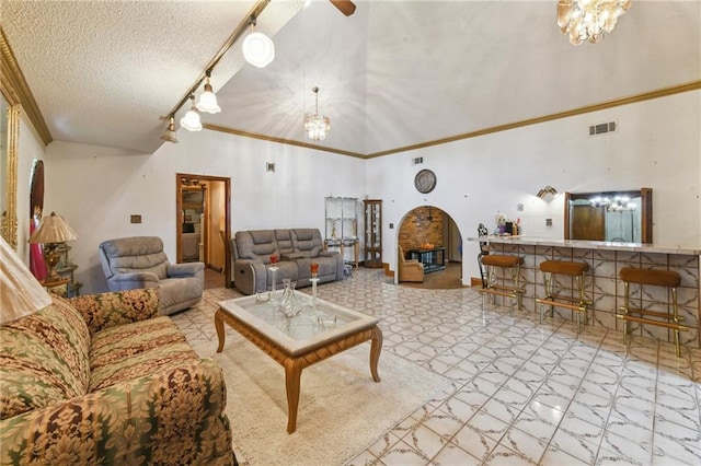 1319 Sumner St, New Orleans, LA 70114 - living area with a chandelier, ornamental molding, a textured ceiling, a towering ceiling, and track lighting