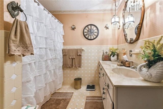 1319 Sumner St, New Orleans, LA 70114 - full bathroom with vanity, wallpapered walls, wainscoting, a textured ceiling, and a shower with curtain