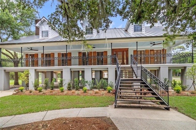 2801 Lakeshore Dr, Mandeville, LA 70448 - view of front of home featuring a standing seam roof, a metal roof, a ceiling fan, stairway, and covered porch
