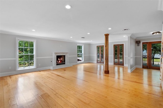 2801 Lakeshore Dr, Mandeville, LA 70448 - unfurnished living room with crown molding, french doors, plenty of natural light, light wood-style floors, and recessed lighting