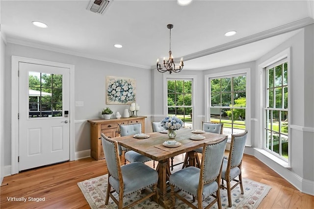 2801 Lakeshore Dr, Mandeville, LA 70448 - dining room with healthy amount of natural light, a chandelier, crown molding, light wood-style flooring, and recessed lighting
