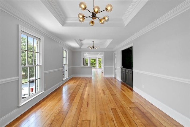 2801 Lakeshore Dr, Mandeville, LA 70448 - unfurnished room with a chandelier, a tray ceiling, plenty of natural light, and ornamental molding