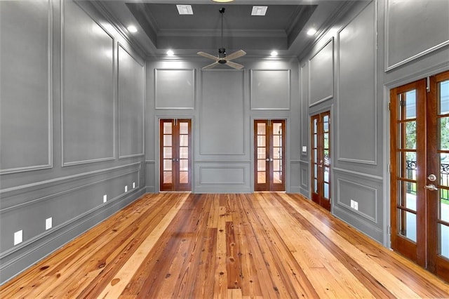 2801 Lakeshore Dr, Mandeville, LA 70448 - empty room with french doors, a decorative wall, light wood finished floors, ornamental molding, and a ceiling fan