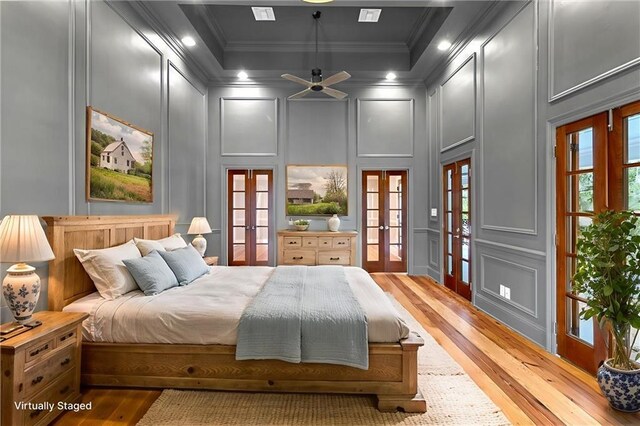 2801 Lakeshore Dr, Mandeville, LA 70448 - bedroom with a decorative wall, french doors, light wood-style flooring, crown molding, and recessed lighting