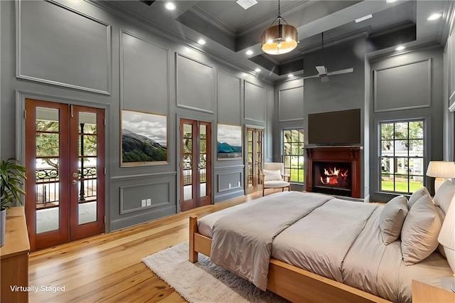2801 Lakeshore Dr, Mandeville, LA 70448 - bedroom featuring a decorative wall, ornamental molding, french doors, light wood-style floors, and access to outside