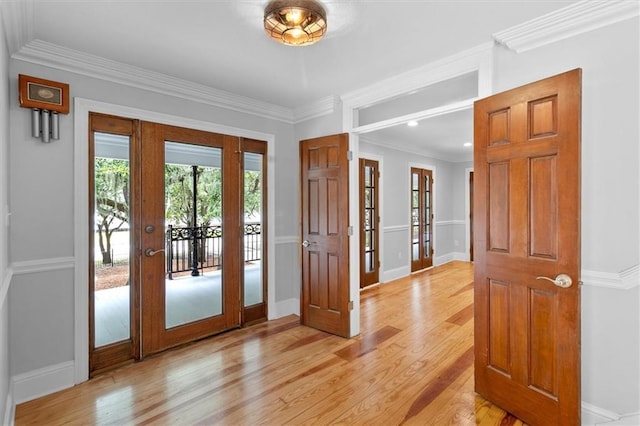 2801 Lakeshore Dr, Mandeville, LA 70448 - entryway featuring french doors, light wood finished floors, ornamental molding, and recessed lighting