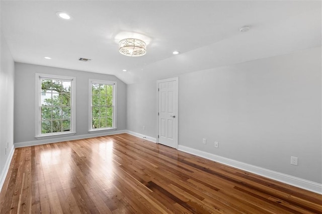 2801 Lakeshore Dr, Mandeville, LA 70448 - empty room featuring wood finished floors, lofted ceiling, recessed lighting, and a smoke detector