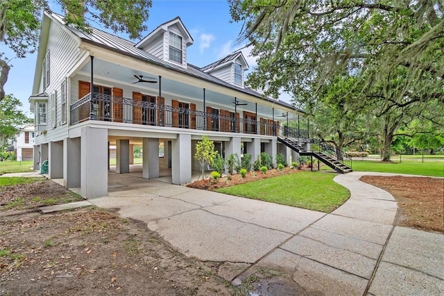 2801 Lakeshore Dr, Mandeville, LA 70448 - view of front of house with ceiling fan, stairs, a front yard, and a porch