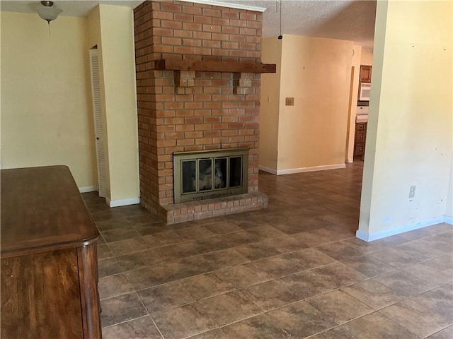 34121 Longleaf Ln, Slidell, LA 70460 - unfurnished living room featuring a brick fireplace and a textured ceiling