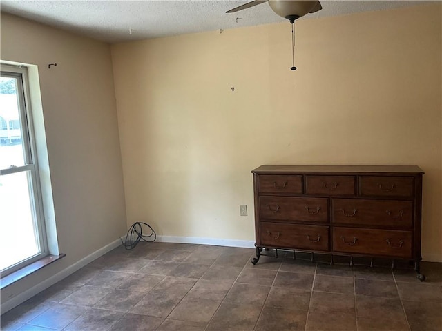 34121 Longleaf Ln, Slidell, LA 70460 - spare room featuring ceiling fan, a textured ceiling, and dark tile patterned flooring