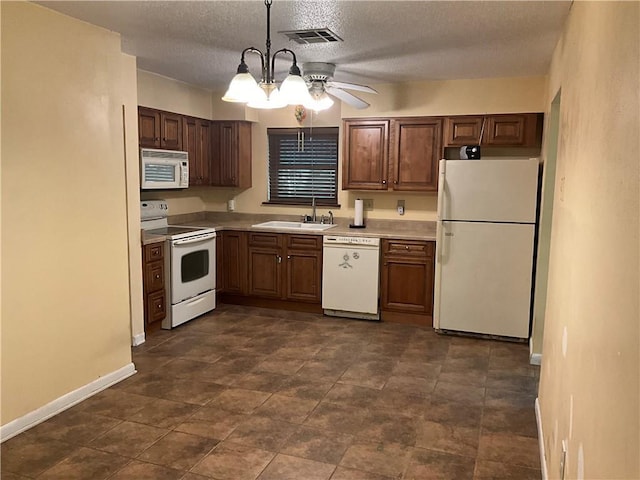 34121 Longleaf Ln, Slidell, LA 70460 - kitchen featuring white appliances, light countertops, a textured ceiling, ceiling fan, and pendant lighting