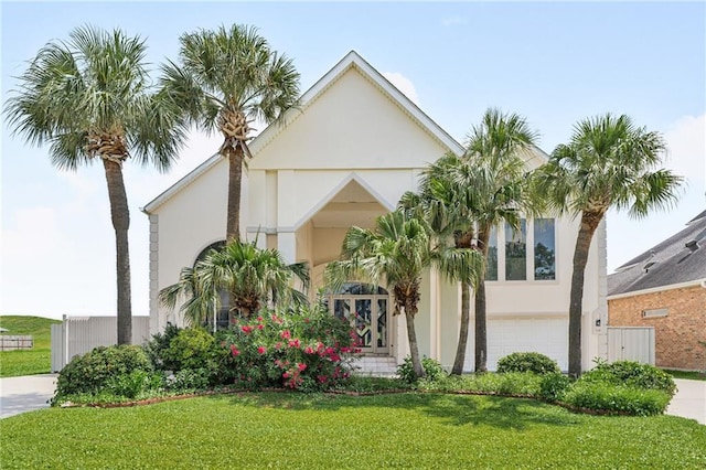 3128 Palm Vista Dr, Metairie, LA 70003 - view of front of house featuring a front yard, stucco siding, an attached garage, and concrete driveway