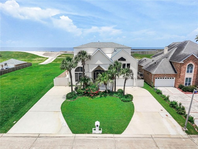 3128 Palm Vista Dr, Metairie, LA 70003 - view of front of home with concrete driveway, stucco siding, an attached garage, and a water view