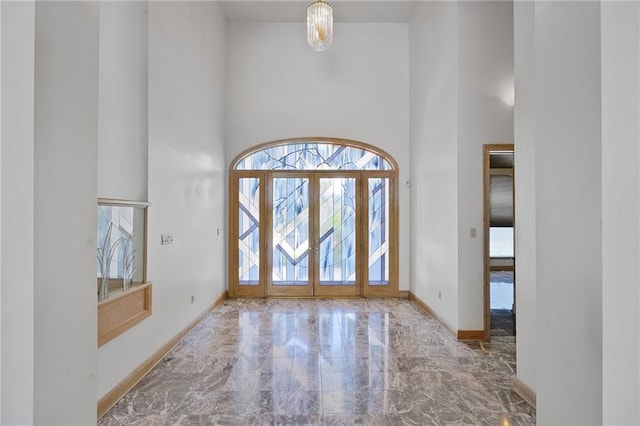 3128 Palm Vista Dr, Metairie, LA 70003 - entryway with a towering ceiling, marble tiled flooring, plenty of natural light, and french doors