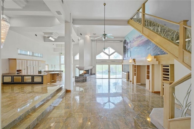 3128 Palm Vista Dr, Metairie, LA 70003 - entrance foyer featuring marble tiled flooring, a towering ceiling, ceiling fan, and a multi sided fireplace
