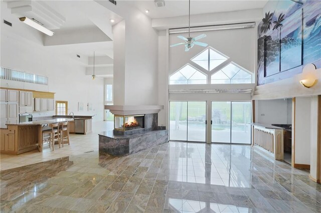 3128 Palm Vista Dr, Metairie, LA 70003 - living area featuring a towering ceiling, plenty of natural light, ceiling fan, a multi sided fireplace, and recessed lighting