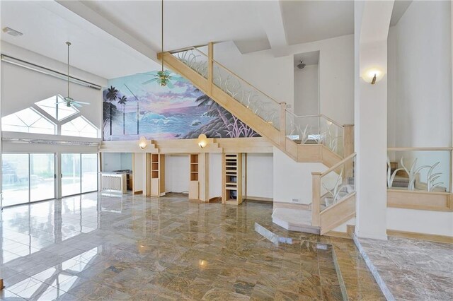3128 Palm Vista Dr, Metairie, LA 70003 - staircase with a towering ceiling, marble tiled flooring, and a ceiling fan