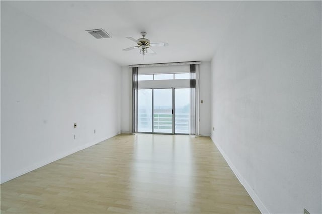 3128 Palm Vista Dr, Metairie, LA 70003 - unfurnished room with a wall of windows, light wood finished floors, and ceiling fan