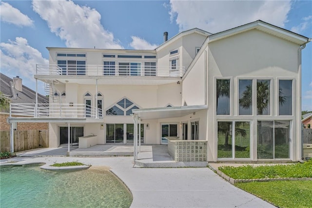 3128 Palm Vista Dr, Metairie, LA 70003 - rear view of property with stucco siding, a balcony, a patio, and an outdoor pool