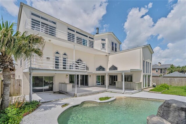 3128 Palm Vista Dr, Metairie, LA 70003 - rear view of house featuring a balcony, stucco siding, and a patio