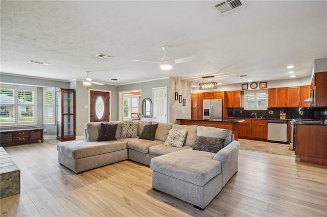 4808 Fairfield St, Metairie, LA 70006 - living room with ceiling fan, healthy amount of natural light, light wood-style flooring, recessed lighting, and a textured ceiling
