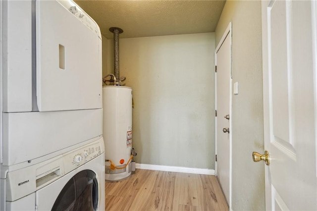 4808 Fairfield St, Metairie, LA 70006 - washroom with gas water heater, stacked washer and clothes dryer, light wood finished floors, and a textured ceiling