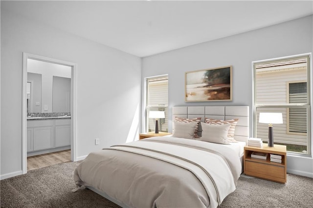 40447 Cara Mae St, Slidell, LA 70461 - bedroom featuring light colored carpet and ensuite bath